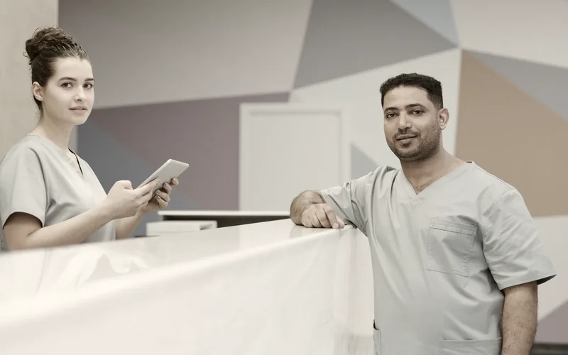 A medical clinic reception desk with staff