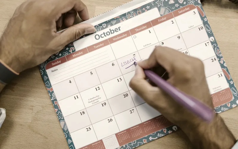 A calendar and pen used for scheduling appointments