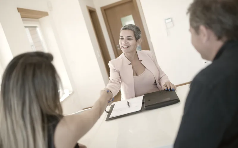 Two people shaking hands at a meeting