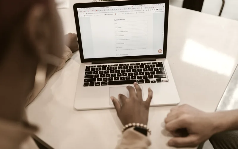 Hands typing on a laptop keyboard