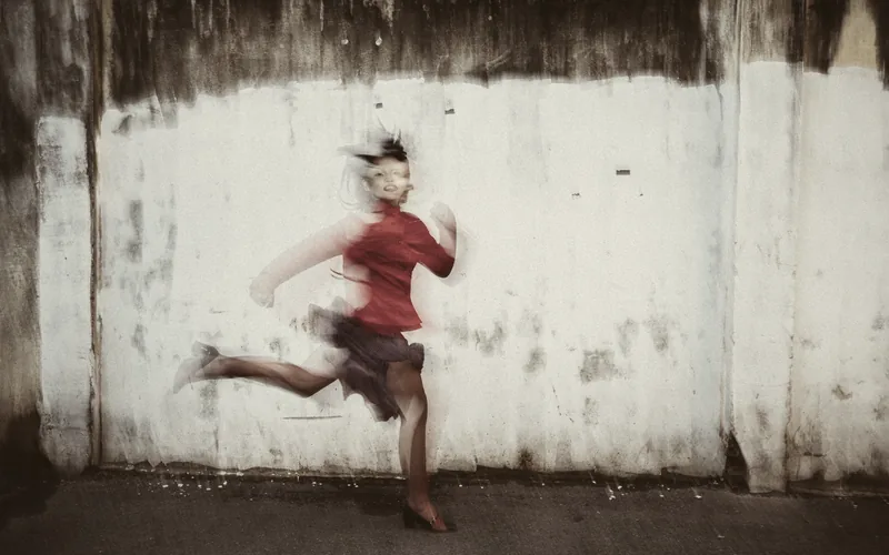 A runner in motion against a wall