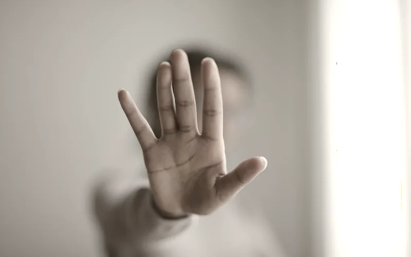 A raised hand signalling stop
